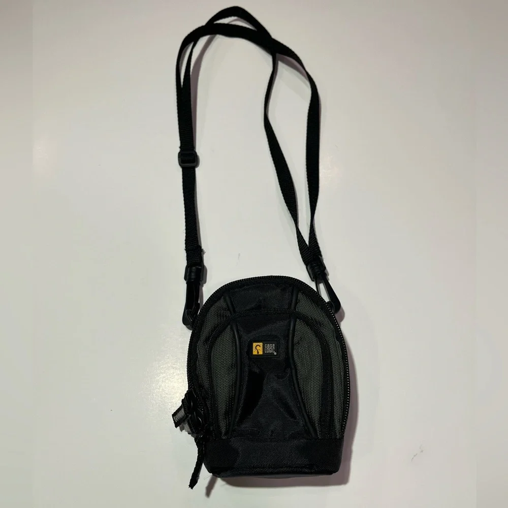 Case Logic Small black/dark green camera case with shoulder strap.